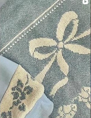 Detail of a floral and bow patterned vintage blanket rebuilt into a hoodie